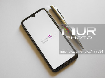 In this photo illustration a Deutsche Telekom logo is display on a smartphone screen and a pencil in Athens, Greece on October 4, 2021. (