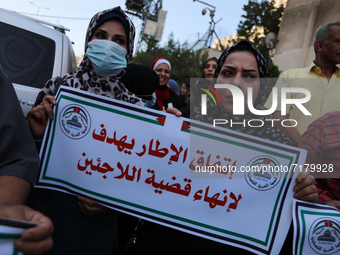Palestinians take part in a protest against the United States and UNRWA signing a Framework for Cooperation in front of the headquarters Uni...