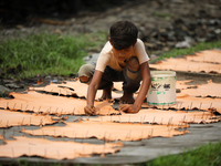A child worker sets up leather pieces on a rack to make it dry at a tannery in Hazaribag, Dhaka, Bangladesh on October 06, 2019.  (