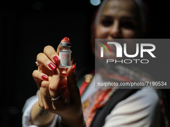 (EDITOR'S NOTE: FILE PHOTO) A healthcare worker holds a vial of the Moderna COVID-19 Vaccine as vaccine uptake among Palestinians increases...