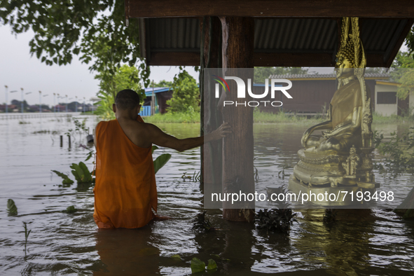 Oct 8, 2021, The monks came to explore the depths of the water that flooded the Buddha images in the temple grounds that were flooded by mon...