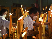 Ethnic Chinese Thai people light up incense sticks and candle at Joe Sue Kung Shrine Chinese temple in Bangkok, Thailand. 10 October 2021. (