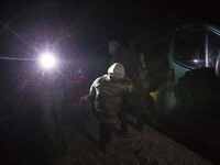 Group of illegal immigrants gest into border guards car after crossing polish belarusian border near Michalowo on October 6, 2021. (