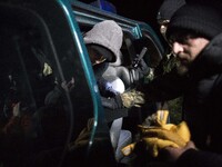Group of illegal immigrants gest into border guards car after crossing polish belarusian border near Michalowo on October 6, 2021. (