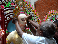 Artist gives final touch to the idol of Hindu Goddess Durga during Durga puja festival in Dhaka, Bangladesh, on October 10, 2021 (