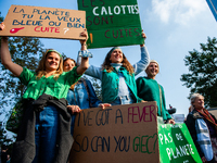 A group of women is holding placards in support of the planet, during the demonstration Back to Climate, organized in Brussels, on October 1...