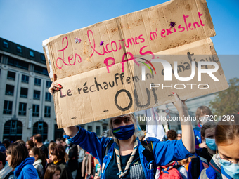 A girl scout is holding a big placard in support of the planet Earth, during the demonstration Back to Climate, organized in Brussels, on Oc...