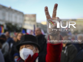 A woman protests showing V-sign gesture during 'We're staying in EU' demonstration at the Main Square in Krakow, Poland on October 10, 2021....