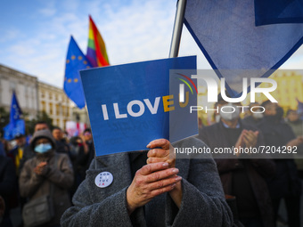 A woman holds 'I Love EU' banner during 'We're staying in EU' demonstration at the Main Square in Krakow, Poland on October 10, 2021. The pr...
