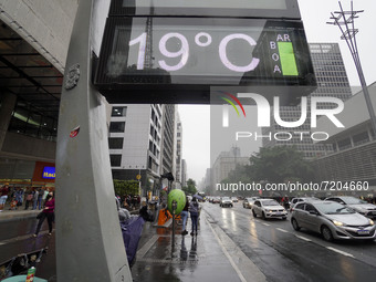 Peopke walk along Avenida Paulista during a rainy afternoon in Sao Paulo, Brazil, on October 11, 2021   (