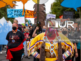 Native American activists lead a march to the White House to protest against the continued use of fossil fuels on Indigenous Peoples' Day, t...