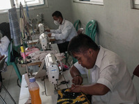A students with a person disability attends sewing training on 12 October, 2021 in Social Service of West Java Province, Cimahi, West Java,...