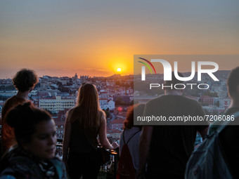 Tourists gather at the Monte viewpoint to enjoy the sunset. Lisbon October 11, 2021. The high places of the Portuguese capital are used by p...