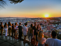 Tourists gather at the Monte viewpoint to enjoy the sunset. Lisbon October 11, 2021. The high places of the Portuguese capital are used by p...