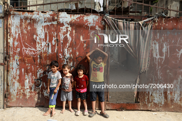 Palestinian children play next to their home in the Gaza Strip's al-Shati refugee camp in Gaza City on October 12, 2021.
 