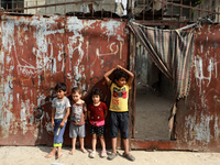 Palestinian children play next to their home in the Gaza Strip's al-Shati refugee camp in Gaza City on October 12, 2021. (