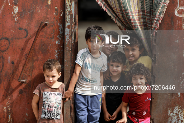 Palestinian children play next to their home in the Gaza Strip's al-Shati refugee camp in Gaza City on October 12, 2021.
 