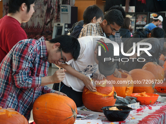 Contestants compete in a pumpkin carving competition the day before Halloween in Ontario, Canada, on October 30, 2013. The winner of the bes...