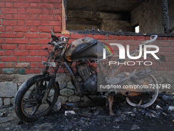A burnt motorcycle lies inside the residential house where a gun battle took place between Indian forces and Kashmiri militants in Tulran vi...