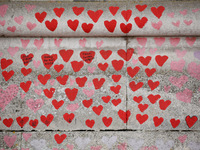 Hearts cover the National Covid Memorial Wall on the south bank footpath of the River Thames opposite the Houses of Parliament in London, En...