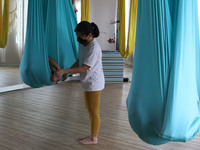Women take an aerial yoga class at Aerial Jooga Studio using masks and health protocols in Serpong, South Tangerang, Indonesia on October 13...