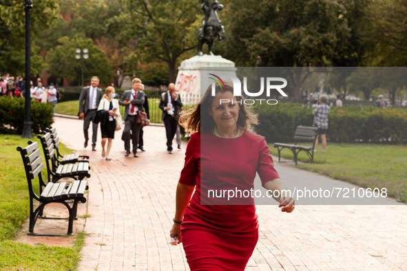 Canadian Finance Minister Chrystia Freeland smirks as she flees a press conference at the White House during a protest by indigenous leaders...