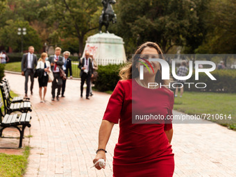 Canadian Finance Minister Chrystia Freeland smirks as she flees a press conference at the White House during a protest by indigenous leaders...