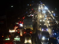 Commuters make their way through a traffic jam at night during Covid-19 Coronavirus pandemic in Dhaka, Bangladesh, on October 13, 2021.Last...