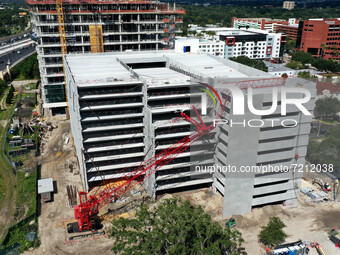 October 13, 2021 - Orlando, Florida, United States - A crane is seen after crashing into a parking garage under construction at the AdventHe...