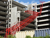 October 13, 2021 - Orlando, Florida, United States - A crane is seen after crashing into a parking garage under construction at the AdventHe...