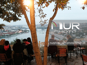 People watching the Golden Horn view from Pierre Loti terrace in Istanbul, Turkey on October 13, 2021. (