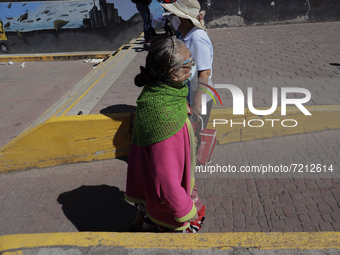 Older adults walk in the streets of downtown Santiago Tulyehualco (Xochimilco), Mexico City, during the COVID-19 emergency and the yellow ep...