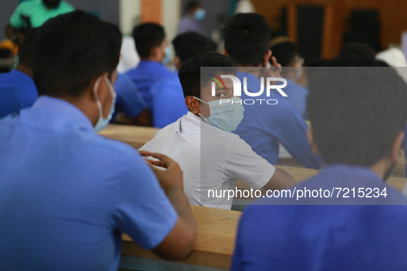 School students sit at Colonel Malek Medical College Hospital to receive a dose of the Covid-19 coronavirus vaccine as trial run vaccination...