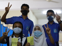 School students show the V sign at Colonel Malek Medical College Hospital after received a dose of the Covid-19 coronavirus vaccine as trial...