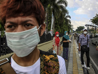 A volunteer give a mask to rider motorcycle at Pekan Baru Riau, Indonesia, at August 06. 2015. During Indonesia’s annual dry season, hundred...