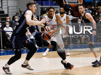 Arturas Gudaitis (L) and Mateusz Ponitka (R) of Zenit in action against Augustine Rubit (C) of Bayern during the EuroLeague Basketball match...