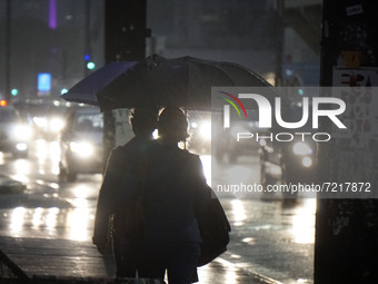 Peopke walk along Avenida Paulista during a rainy night in Sao Paulo, Brazil, on October 14, 2021 (