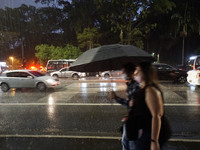 Peopke walk along Avenida Paulista during a rainy night in Sao Paulo, Brazil, on October 14, 2021 (