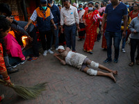A Nepalese Hindu devotee rolls on the ground as part of rituals to celebrate the tenth day of Dashain Festival  at Baramahini Temple in Bhak...