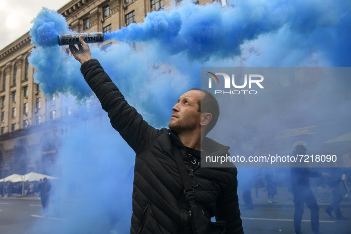 Veterans of Russian-Ukrainian war , activists and supporters of Ukraine's nationalist movements,  burn smoke grenades during a procession to...