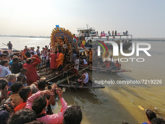 An idol of Durga is seen ferried to deep parts of Ganges river for immersion , on the last day of Durga puja festival in Kolkata , India , o...