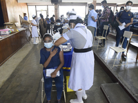 A Sri Lankan School Student receiving his first dose Pfizer-BioNTech vaccine in a vaccination center near Colombo, Sri Lanka October 15, 202...