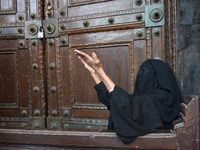 A Kashmiri women sits outside Kashmir's grand mosque Jamia Masjid after authorities disallowed the friday prayers in Srinagar, Indian Admini...
