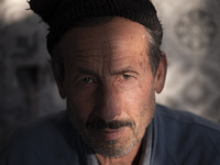 Abdolghani Jamshidi-60, An Afghan refugee who works as a construction worker, looks on as he poses for a photograph during his break-time wh...