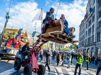 People are dancing behind one of the trucks during the colorful ADEV parade in Amsterdam. Every year, the ADEV demonstrators dance for creat...