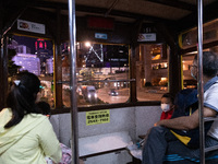 A family rides the tram in Central Hong Kong. (