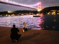 Woman photographed under Fatih Sultan Mehmet Bridge in Istanbul on October 16, 2021. (