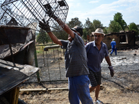 Men are loading a cart with burnt furniture from one of the houses destroyed by the fire Valcha polyana, Elhovo, Bulgaria on August 07, 2015...