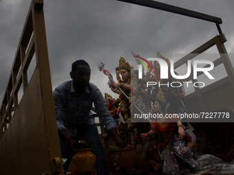 Goddess Durga's idol is seen on the banks of Kuakhai River as devotees immerse it in the river water on the end rituals of five days long Du...