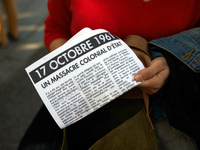 A protester shows a paper reading 'October 17th 1961 a state colonialist slaughter'. Dozens of protesters walk to commerorate the 60th anniv...